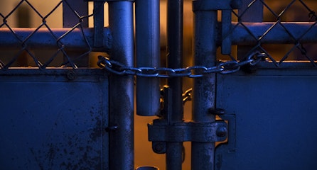 caption: A locked gate is shown at an outdoor play court at View Ridge Elementary School in northeast Seattle on Thursday, November 19, 2020. A Seattle Schools investigation revealed that a second-grade boy had been placed in this enclosure, dubbed “the cage” by school staff members, on multiple occasions during the school day.