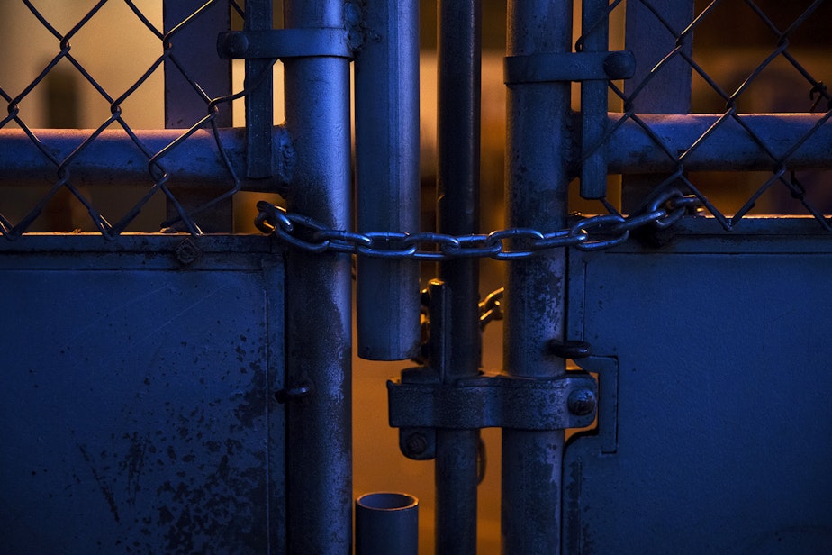 caption: A locked gate is shown at an outdoor play court at View Ridge Elementary School in northeast Seattle on Thursday, November 19, 2020. A Seattle Schools investigation revealed that a second-grade boy had been placed in this enclosure, dubbed “the cage” by school staff members, on multiple occasions during the school day.