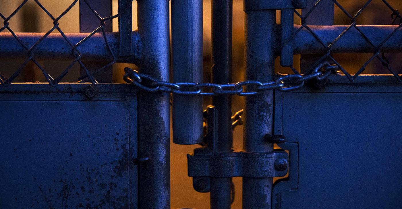 caption: A locked gate is shown at an outdoor play court at View Ridge Elementary School in northeast Seattle on Thursday, November 19, 2020. A Seattle Schools investigation revealed that a second-grade boy had been placed in this enclosure, dubbed “the cage” by school staff members, on multiple occasions during the school day.