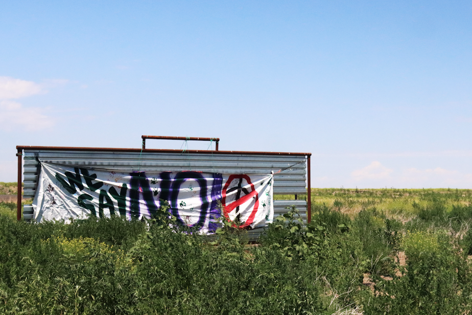 caption: One of the many protest signs against the Lava Ridge Wind Project that is posted on the road leading into Minidoka prison camp in rural Idaho.