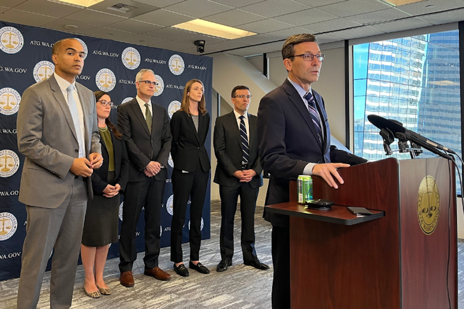 caption: Washington state Governor-elect Bob Ferguson (at lectern) and the next attorney general, Nick Brown (left), give a press conference on their preparations for a second Trump presidency on Nov. 7, 2024.