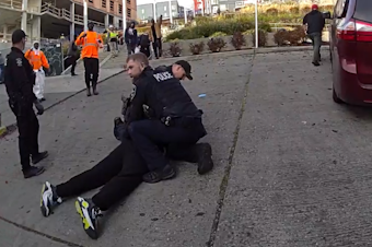 caption: After a pursuit through Little Saigon, Seattle police arrest a suspect who allegedly stabbed five people nearby on Friday, Nov. 8, 2024. The incident on Friday was part of a string of stabbings in less than two days that had the neighborhood on edge.  