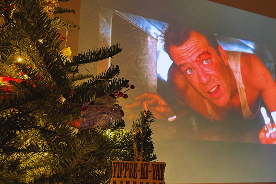 caption: Ever since the movie "Die Hard" hit screens in 1988, its status as a Christmas movie has grown. Today, it's a Christmas tradition for many, but others debate its place in Christmas movie canon. 