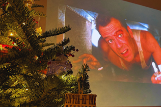 caption: Ever since the movie "Die Hard" hit screens in 1988, its status as a Christmas movie has grown. Today, it's a Christmas tradition for many, but others debate its place in Christmas movie canon. 