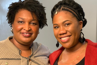 caption: Stacey Abrams, left, of Fair Fight, and Seattle journalist Jenna Hanchard.